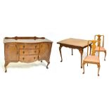 A reproduction walnut dining suite comprising draw leaf dining table raised on cabriole supports,