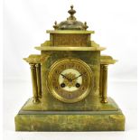 An early 20th century onyx mantel clock with gilt metal Corinthian columns surrounding a circular