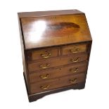 An Edwardian mahogany inlaid and crossbanded bureau with fitted interior above two short and three