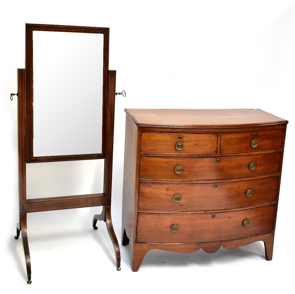 An Edwardian mahogany and inlaid cheval mirror on four legs to casters, 150 x 64cm, and a bow