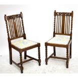 A set of four 1920s/30s oak dining chairs, raised on barleytwist supports.