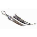 An Iraqi white metal and niello enamel decorated dagger with curved steel blade in scabbard