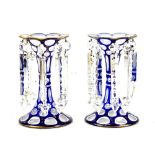 A pair of late 19th century clear, white and blue glass lustres with gilt floral detail and