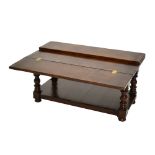 An oak rectangular coffee table, with fold-out top on ring turned baluster supports to under tier,