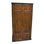 OLD CHARM; an oak two door wardrobe with linen fold detail, 191 x 102cm.