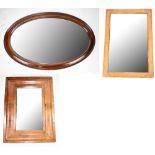 An early 20th century oak framed rectangular wall mirror together with two further wall mirrors (