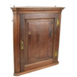 An oak and mahogany flat fronted corner cupboard (af).