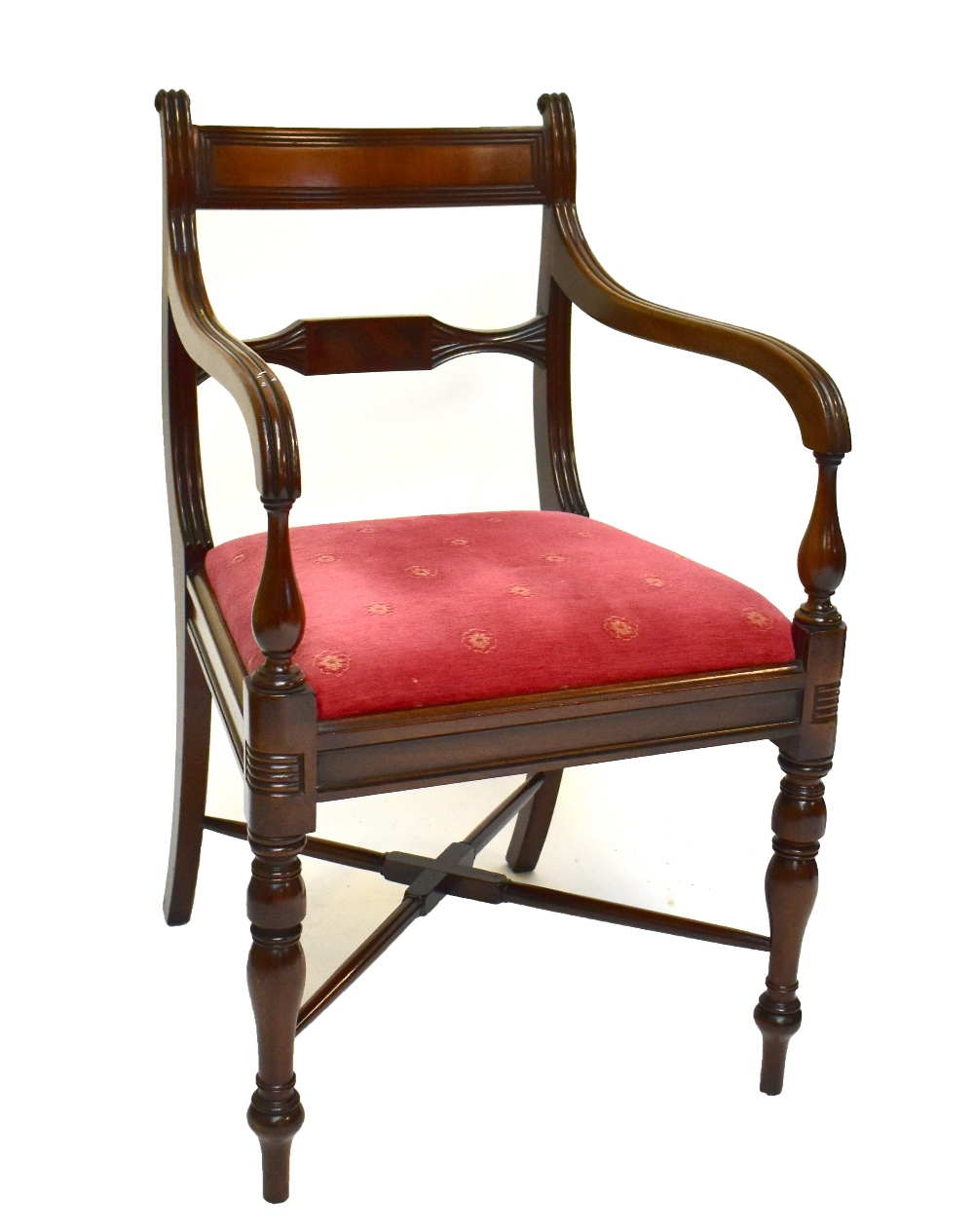 A Regency mahogany bar back elbow chair with fluted swept arms, padded drop-in seat and ring