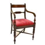 A Regency mahogany bar back elbow chair with fluted swept arms, padded drop-in seat and ring