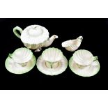 BELLEEK; a green Neptune part tea service, comprising teapot, milk jug, cups and saucers.