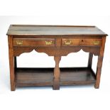 An 18th century oak dresser base, with two central drawers above undertier shelf, width 127cm.