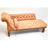 A late 19th century oak framed chaise longue in floral upholstery, length 190cm.