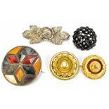 A small group of brooches to include a Scottish white metal agate example, a yellow metal rounded
