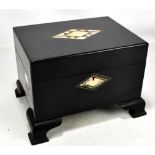 A black ebonised Victorian jewellery box with mother of pearl cartouche, on later feet, length