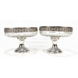 A pair of 19th/early 20th century French silver mounted clear cut glass pedestal bowls with repoussé