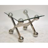 EICHHOLTZ; a glass topped square coffee table on stainless steel X-framed supports, length 65 x
