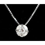 An 18ct white gold and diamond pendant, the floral drop set with central round brilliant cut stone