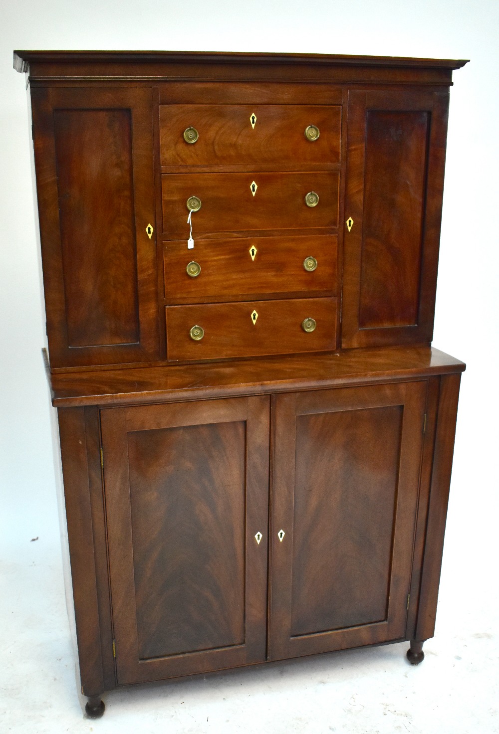 A mid-19th century mahogany side cabinet, the upper section with four drawers and two cupboard doors