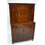 A mid-19th century mahogany side cabinet, the upper section with four drawers and two cupboard doors