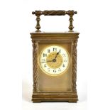 A late 19th century French brass carriage clock, the circular dial set with Arabic numerals,