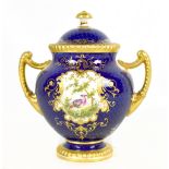 COALPORT; a hand painted twin handled lidded vase decorated with a central hand painted panel
