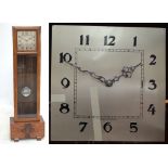 A 1940s walnut veneered Art Deco longcase clock with silver dial set with Arabic numerals and triple