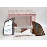 A pink painted upcycled kitchen table with a patchwork stickered top, disassembled model pond