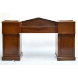 A 19th century burr walnut drop centre twin pedestal sideboard of architectural form with central