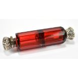 A 19th century faceted ruby glass double ended scent bottle with unmarked white metal mounts