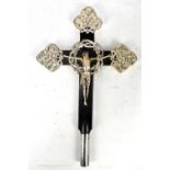 An Arts and Crafts wooden crucifix with silvered metal mounts featuring Christ against crown of
