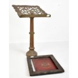 A brass bible stand with pierced decoration, height 44cm, also a framed painted armorial