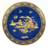 WILTSHAW & ROBINSON, CARLTON WARE; a large chinoiserie decorated blue ground charger, printed