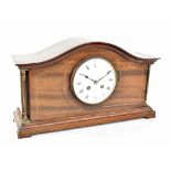 An Edwardian inlaid mahogany arch topped mantel clock, the enamel dial with Roman numerals, raised