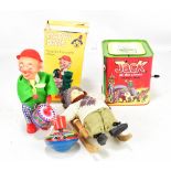 A small group of toys to include a Jack at the Circus music box, a doll on a sledge, etc and
