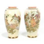 A pair of Meiji period Satsuma vases painted with landscapes each featuring pagoda amongst hills and