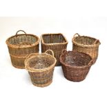 Five twin handled wicker baskets, the largest diameter approx 68cm (5).