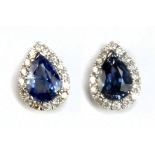 A pair of 14ct white gold sapphire and diamond ear studs, sold with World Gemological Institute