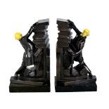 A pair of early 20th century bronzed spelter and ivorine bookends, modelled as an elderly