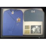 A framed and glazed display containing an original 1966 Wembley Stadium seat back numbered 84 (