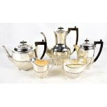 JOHN HENRY POTTER; a George V hallmarked silver three piece coffee set with gadrooned detail,