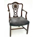 A George III mahogany oversized elbow chair with pierced splat back, carved swept arms, padded