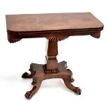 A William IV mahogany tea table with carved detail on quadripartite base to four paw feet on