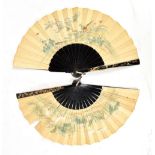 Two early 20th century Japanese paper fans featuring landscapes and birds amongst flowers to each