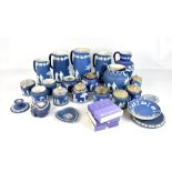 WEDGWOOD; a large quantity of blue jasper dip relief decorated items including jugs, preserve