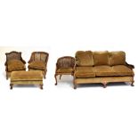 A good early 20th century stained beech double caned five piece bergère suite comprising settee,