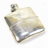 An early 20th century hallmarked silver curved hip flask with detachable cup, approx 4.3ozt/134g.