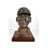 A bronzed ceramic bust depicting Sir Francis Chichester, raised on mahogany plinth base, height