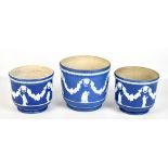 WEDGWOOD; three blue jasper dip small jardinières with relief decoration, height of largest 16.5cm.