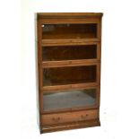 A Globe-Wernicke style oak four section stacking bookcase with glazed hinged doors above single