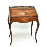 A late 19th/early 20th century French tulipwood and marquetry bureau de dame of bombé outline